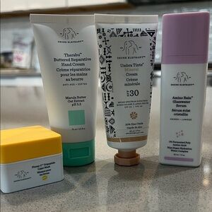 Drunk Elephant Skincare Collection with White, Orange, and Yellow Accents